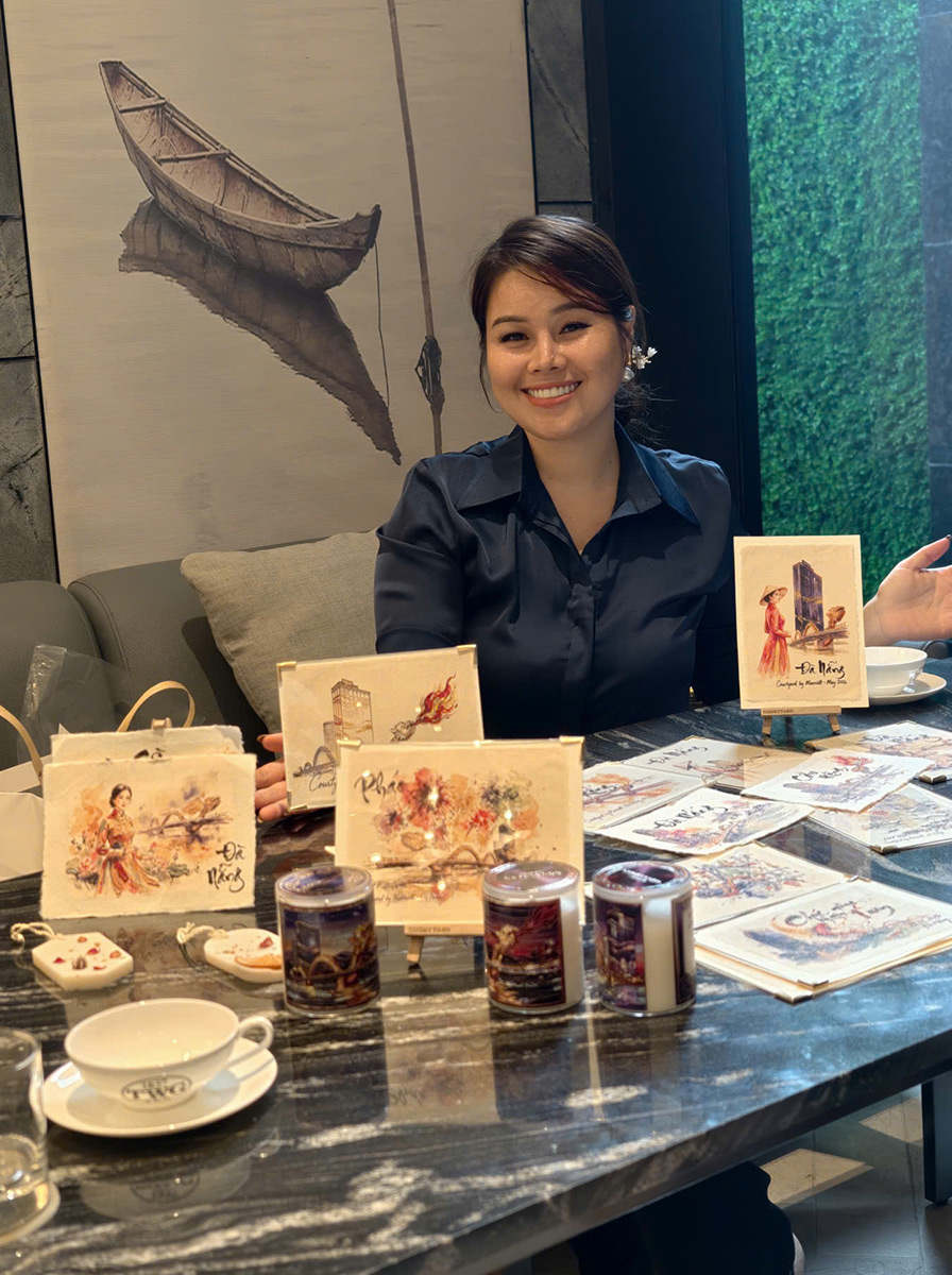 A Vietnamese woman presenting a sheet of Dó paper inside a gallery